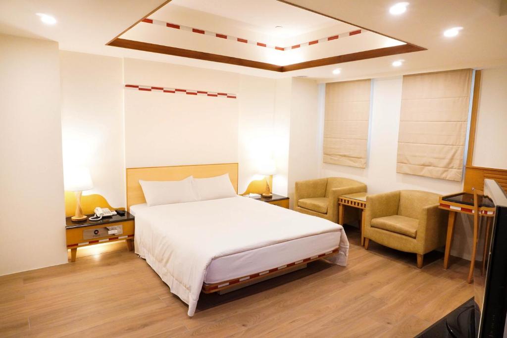 Postel nebo postele na pokoji v ubytování Kao Yuan Hotel - Zhong Zheng