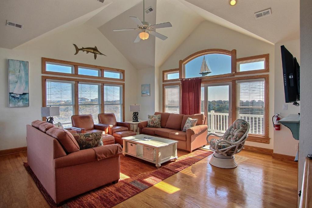 a living room with furniture and a large window at Blue Waters #18-22 in Avon