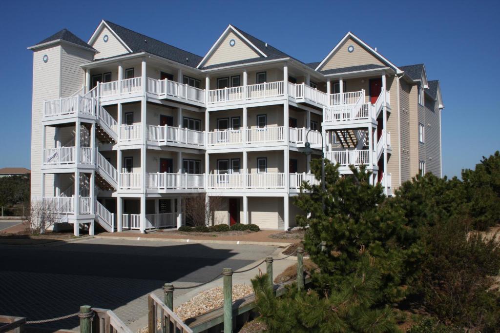 a large white apartment building with white balconies at Hwy 12 Slash Creek Condos in Hatteras