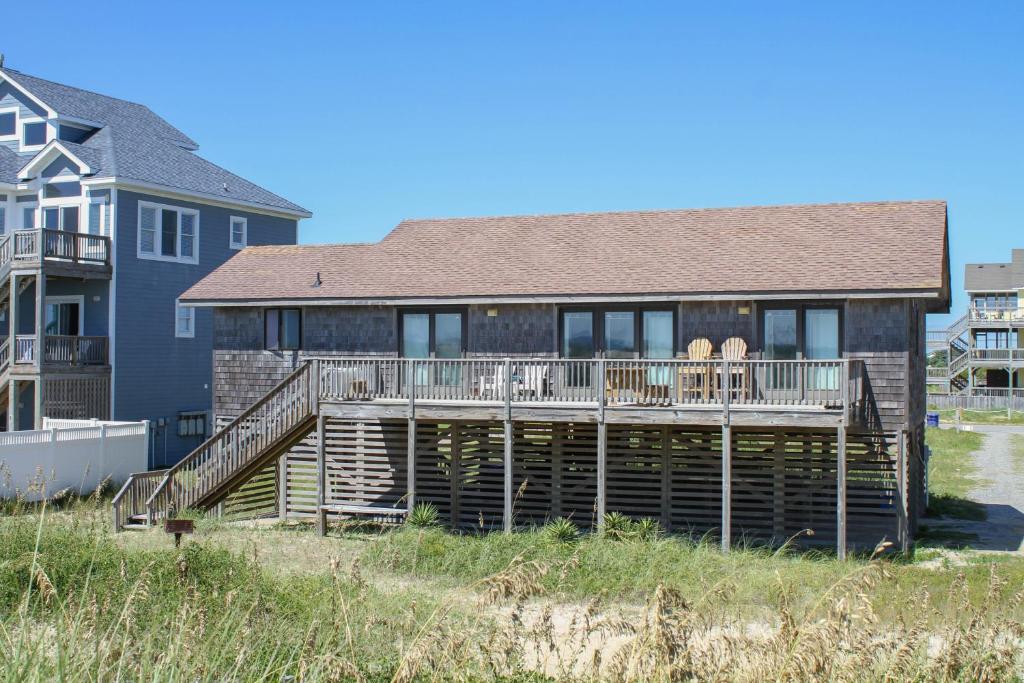 a house with a deck on the beach at Hunter Haven #6HHH in Hatteras