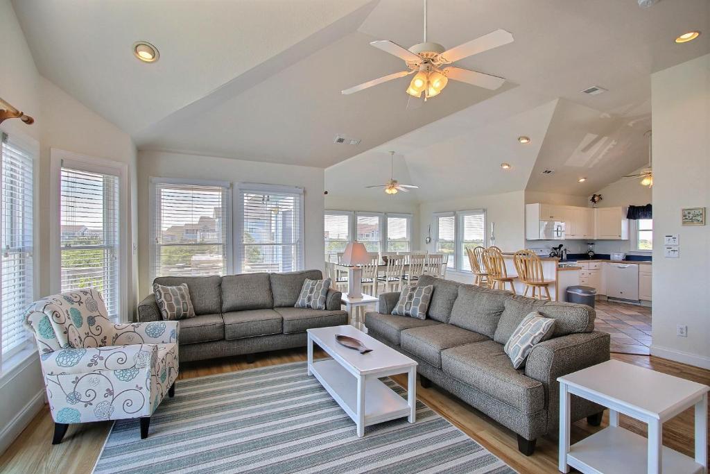 a living room with a couch and a table at Pamlico Sunset #8-9 in Avon