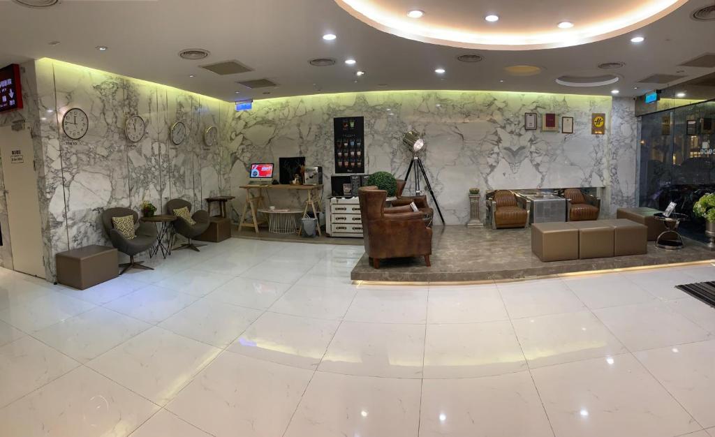 a lobby of a store with couches and tables at Chao She Hotel in Kaohsiung