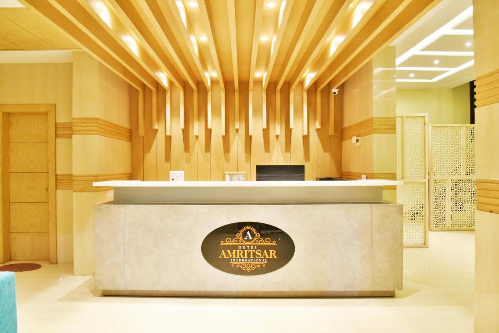 a lobby of the embassy of australia with a logo at Hotel Amritsar International in Amritsar