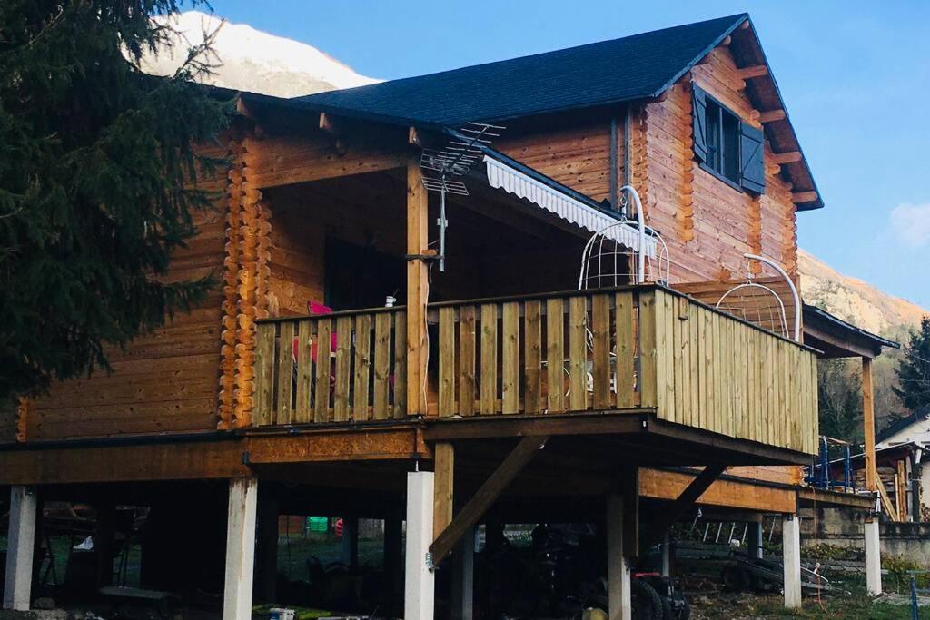 a log cabin with a porch and a balcony at Chalet Bois Laruns in Laruns
