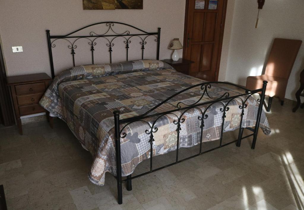 a bedroom with a bed with a wrought iron bed frame at Sogno Salento in Guagnano