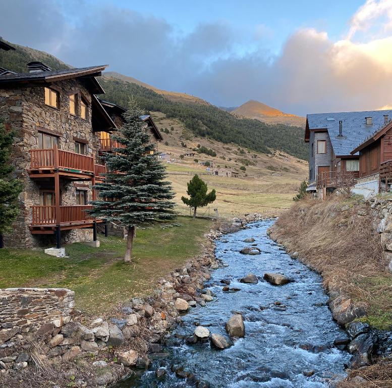 a river in front of a house and a river sidx sidx sidx at Kione DeuSol in Incles