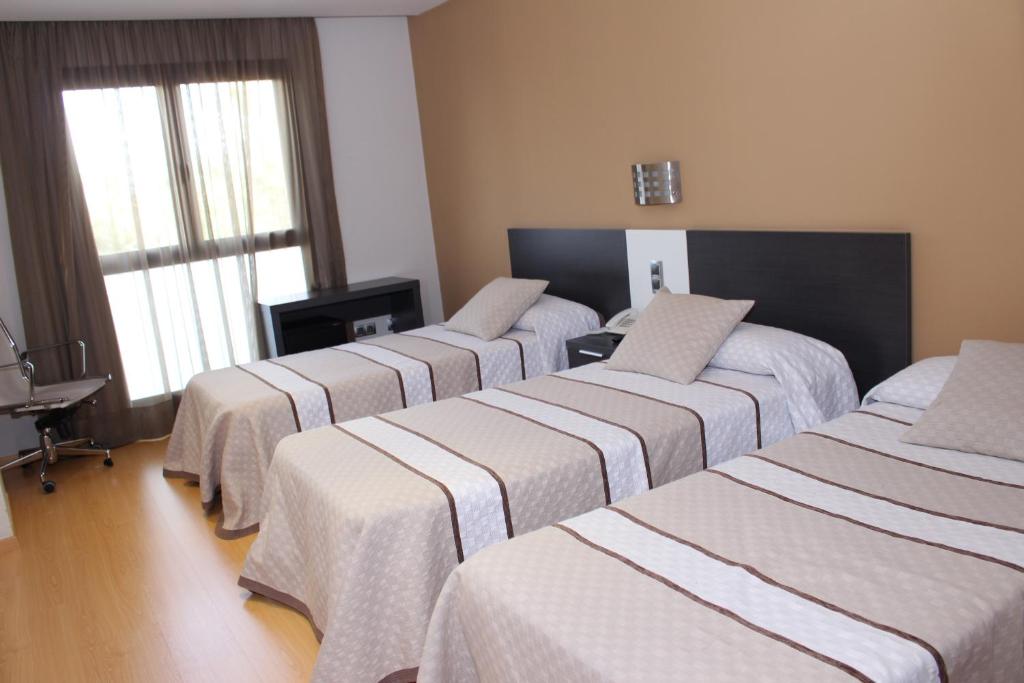 Posteľ alebo postele v izbe v ubytovaní Hotel Ciutat d'Amposta