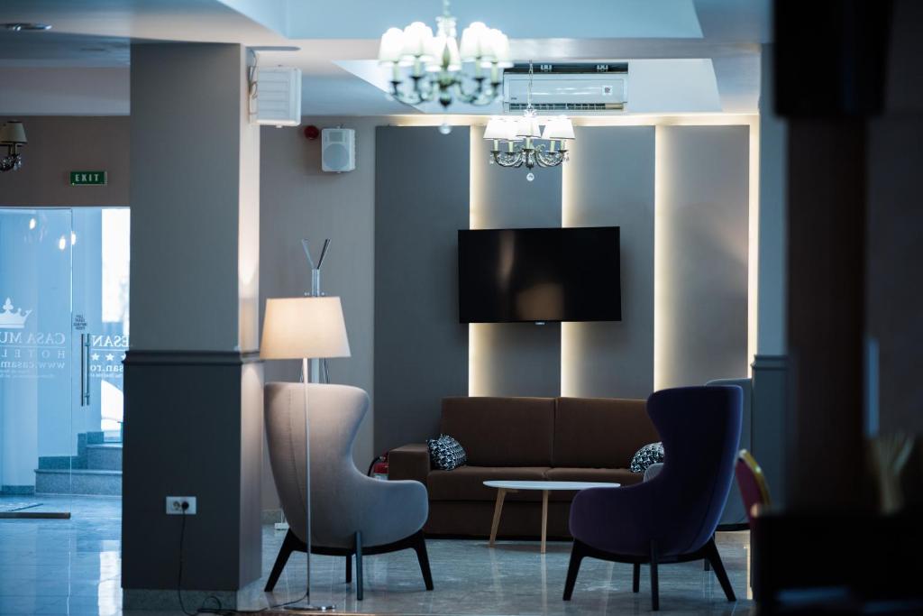 a living room with a couch and chairs and a table at Casa Mureșan in Braşov