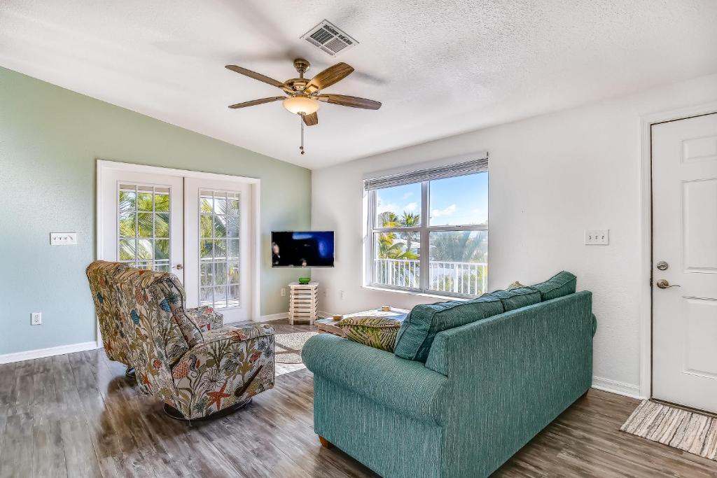 a living room with a couch and a ceiling fan at Cayo Loco in Little Torch Key
