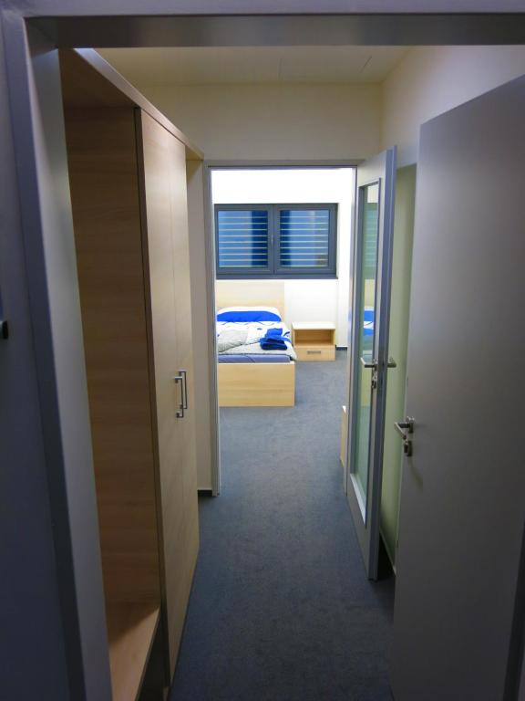 a hallway with a room with a bed and a window at Elmontex Air in Mošnov