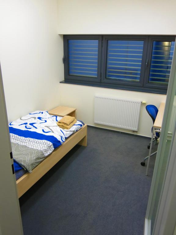 a bedroom with a bed and a desk and a chair at Elmontex Air in Mošnov