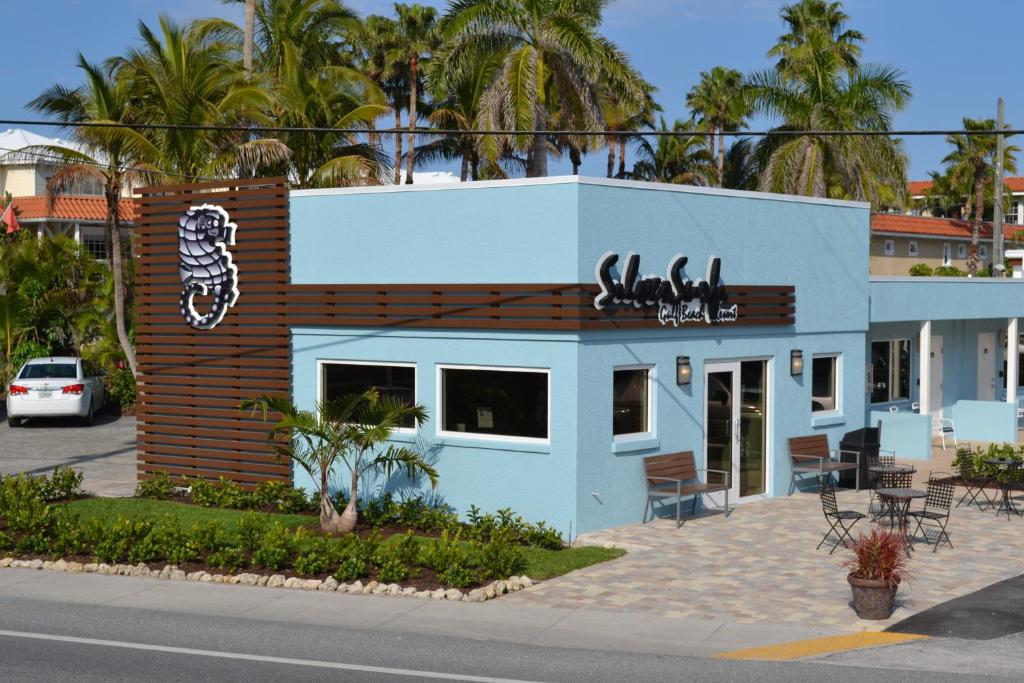 a restaurant with a sign on the side of the building at Silver Surf Gulf Beach Resort in Bradenton Beach