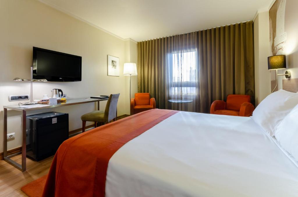 Postel nebo postele na pokoji v ubytování Hotel Marques De Pombal