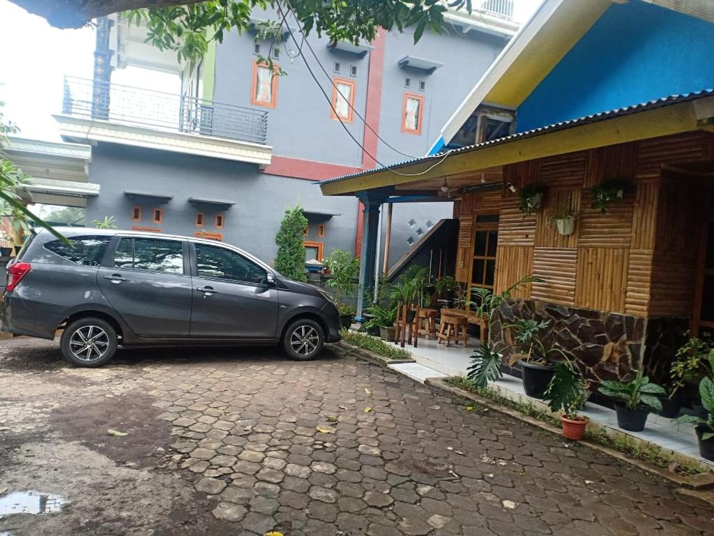 a car parked in front of a building at Budhis Home in Bromo