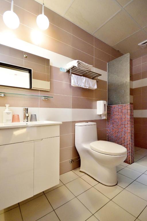 a bathroom with a toilet and a sink at Taitung Venice B&amp;B in Taitung City