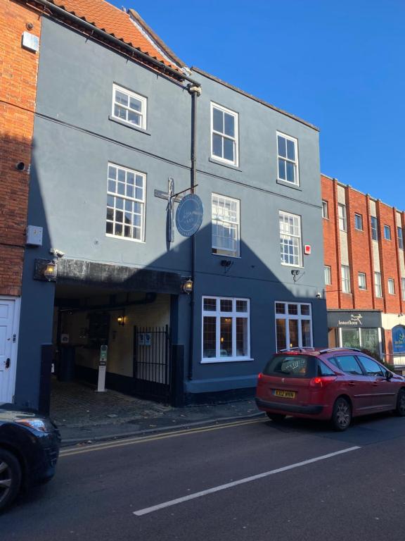 a red car parked in front of a building at Watergate YARD in Sleaford