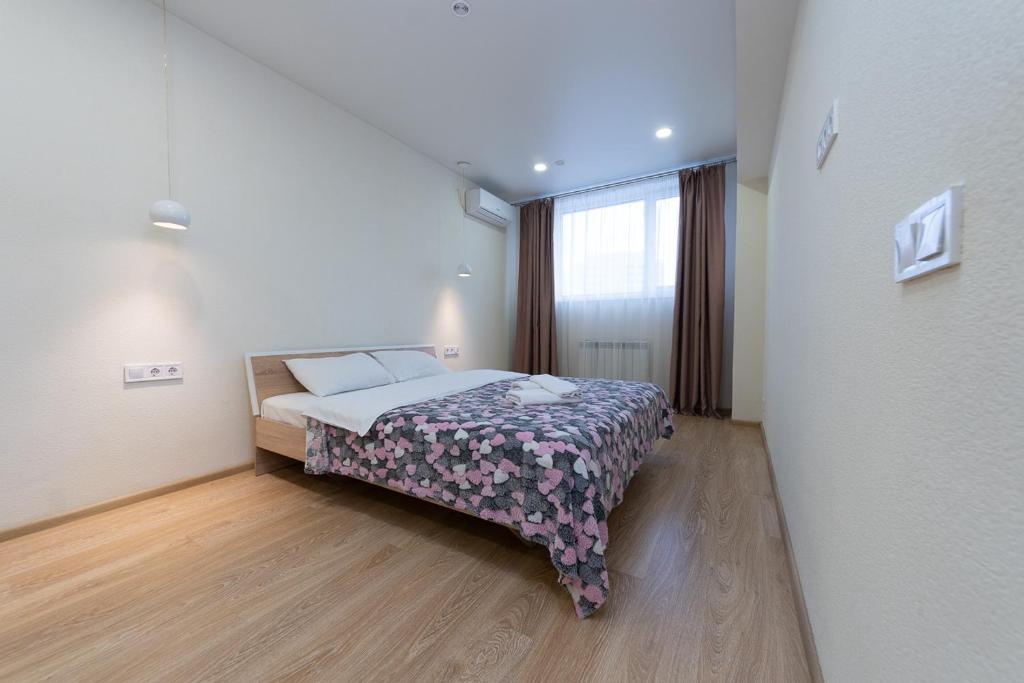 een slaapkamer met een bed in een kamer met een raam bij FlatRent SmartHouse in Kiev