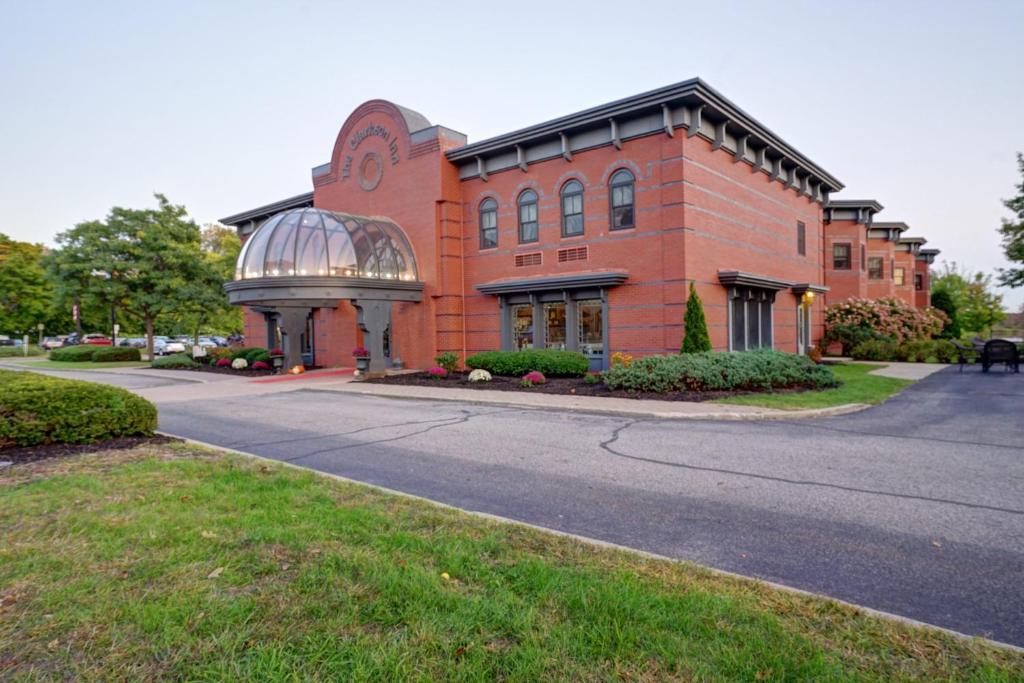 a brick building with a glass dome on a street at The Clarkson Inn in Potsdam