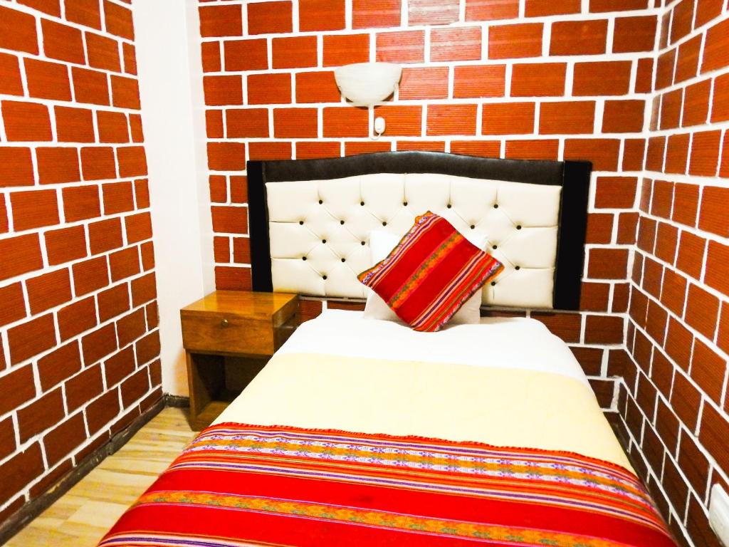 Postel nebo postele na pokoji v ubytování Hostal Encanto Machupicchu