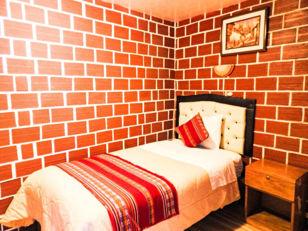 Postel nebo postele na pokoji v ubytování Hostal Encanto Machupicchu