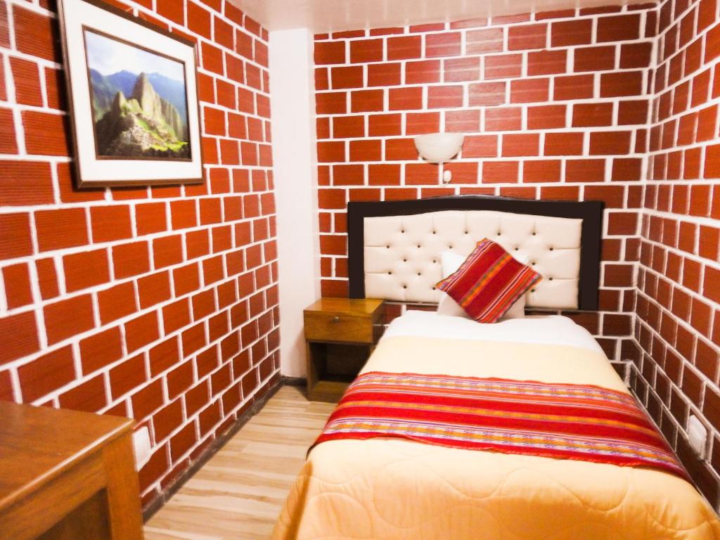 Postel nebo postele na pokoji v ubytování Hostal Encanto Machupicchu