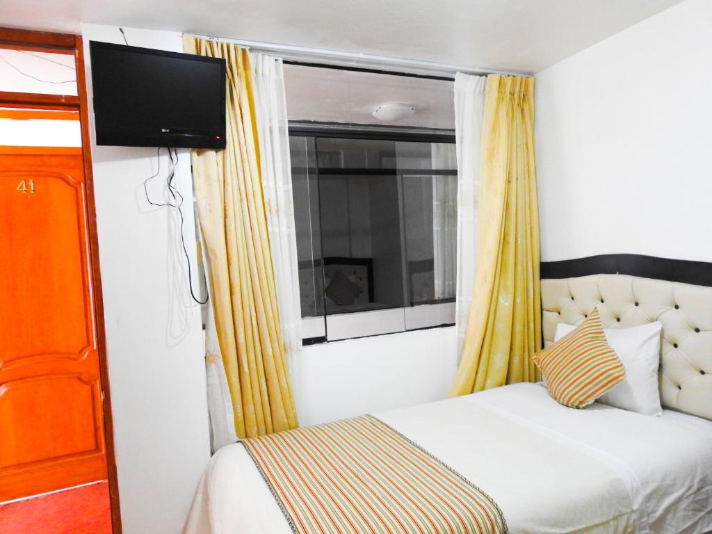 Postel nebo postele na pokoji v ubytování Hostal Encanto Machupicchu