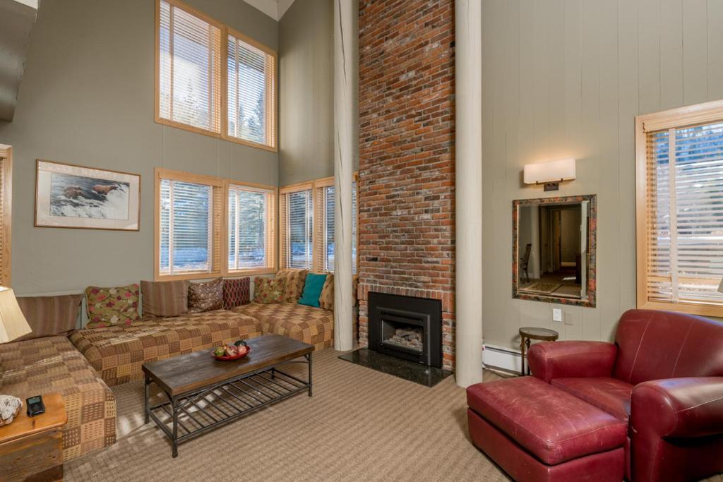 a living room with a couch and a fireplace at Prospector 205 in Ketchum