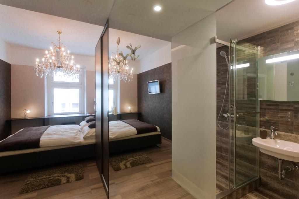 a bedroom with a bed and a shower and a sink at Piu Trendy Rooms in Zagreb
