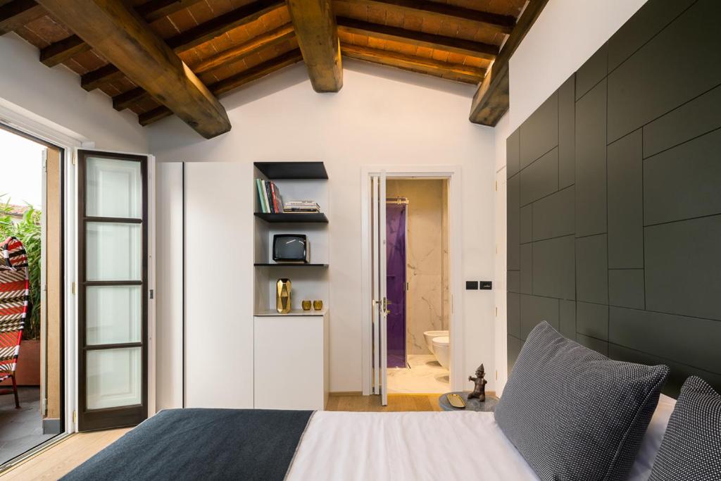 Postel nebo postele na pokoji v ubytování Hotel Milu Florence