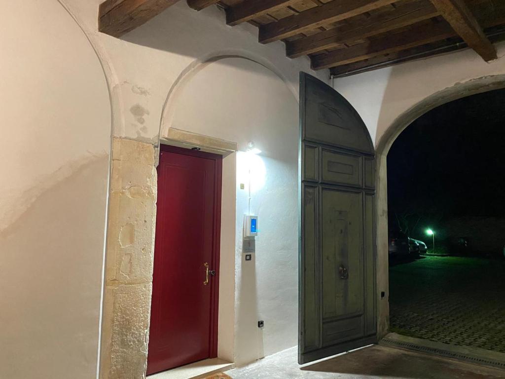 een ingang naar een gebouw met een rode deur bij Casa Charleston in Palazzo Nobiliare al Duomo in Padua