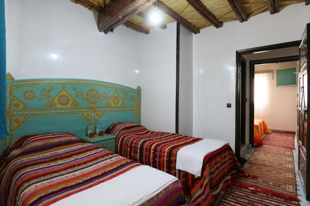 Postel nebo postele na pokoji v ubytování Kasbah Du Roches Armed