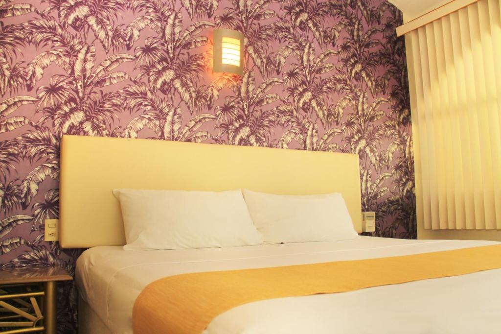 Postel nebo postele na pokoji v ubytování Hotel Gran Palmeiras