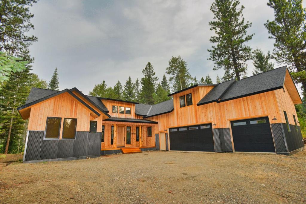 a large wooden house with two garage at White Bark Lodge by Casago McCall - Donerightmanagement in McCall