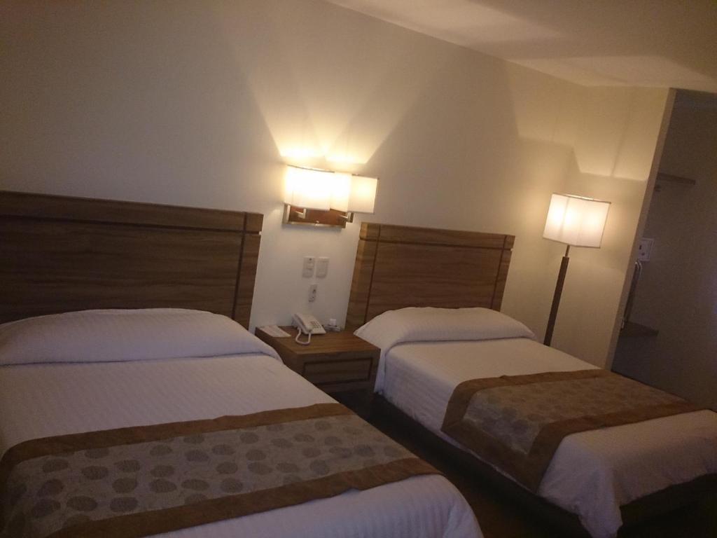 Postel nebo postele na pokoji v ubytování Hotel Oliver Inn - Business Class