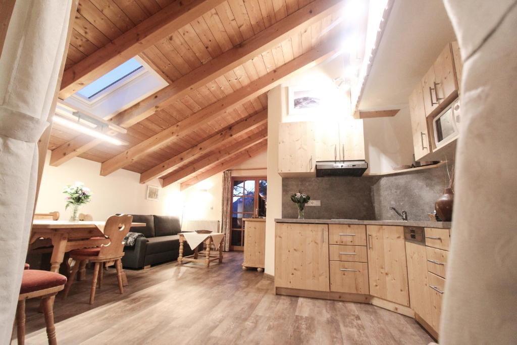 a kitchen and living room with a table and chairs at Appartementhaus Schirsner in Schliersee