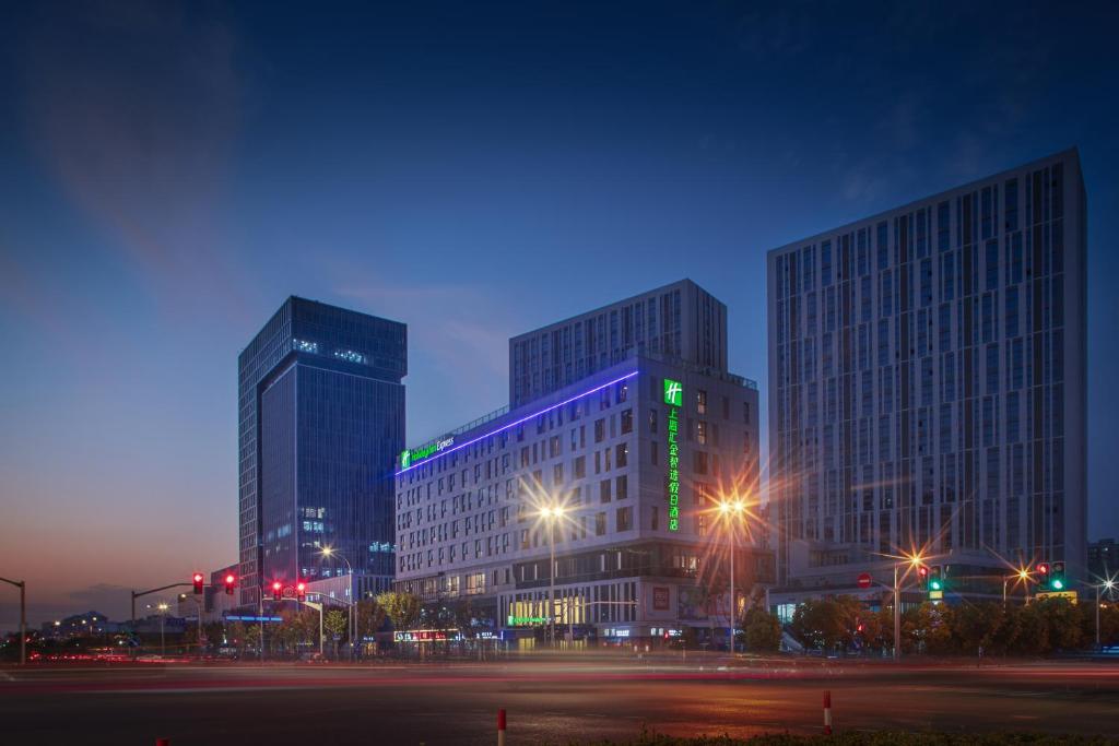 a city with tall buildings at night with at Holiday Inn Express Shanghai Huijin, an IHG Hotel in Shanghai