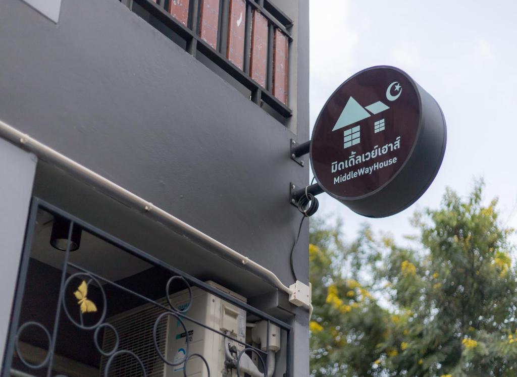 a sign on the side of a building at MiddleWay House Bangkok in Bangkok