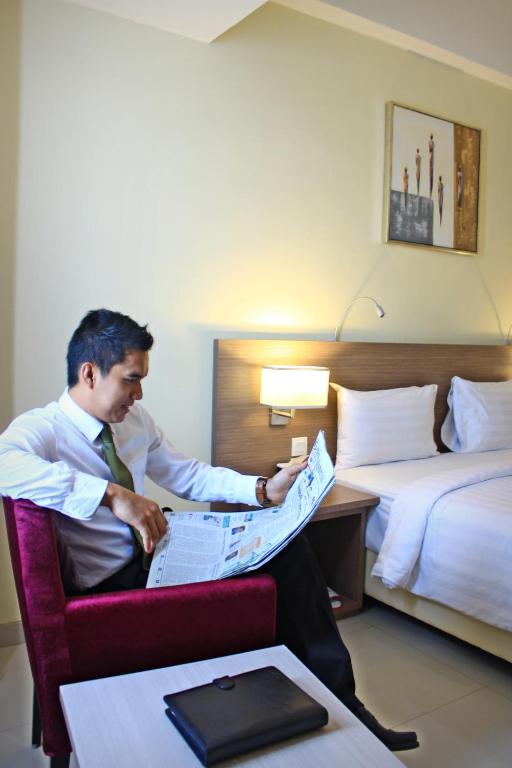 Postel nebo postele na pokoji v ubytování Biz Hotel Batam