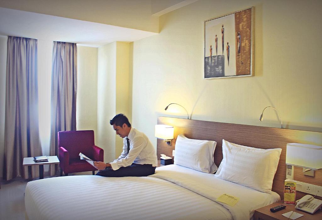 Postel nebo postele na pokoji v ubytování Biz Hotel Batam