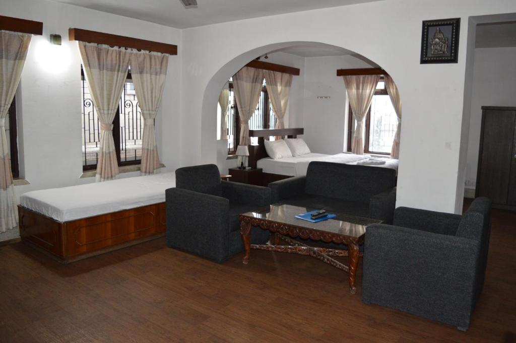 a bedroom with a bed and a living room at Apartment in Nepal in Kathmandu