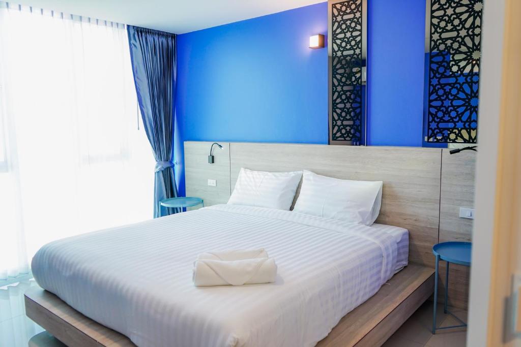 Postel nebo postele na pokoji v ubytování วัน บัดเจท เชียงราย สนามบิน One Budget Hotel Chiangrai Airport