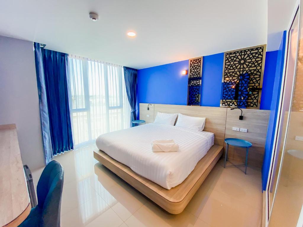 Postel nebo postele na pokoji v ubytování วัน บัดเจท เชียงราย สนามบิน One Budget Hotel Chiangrai Airport