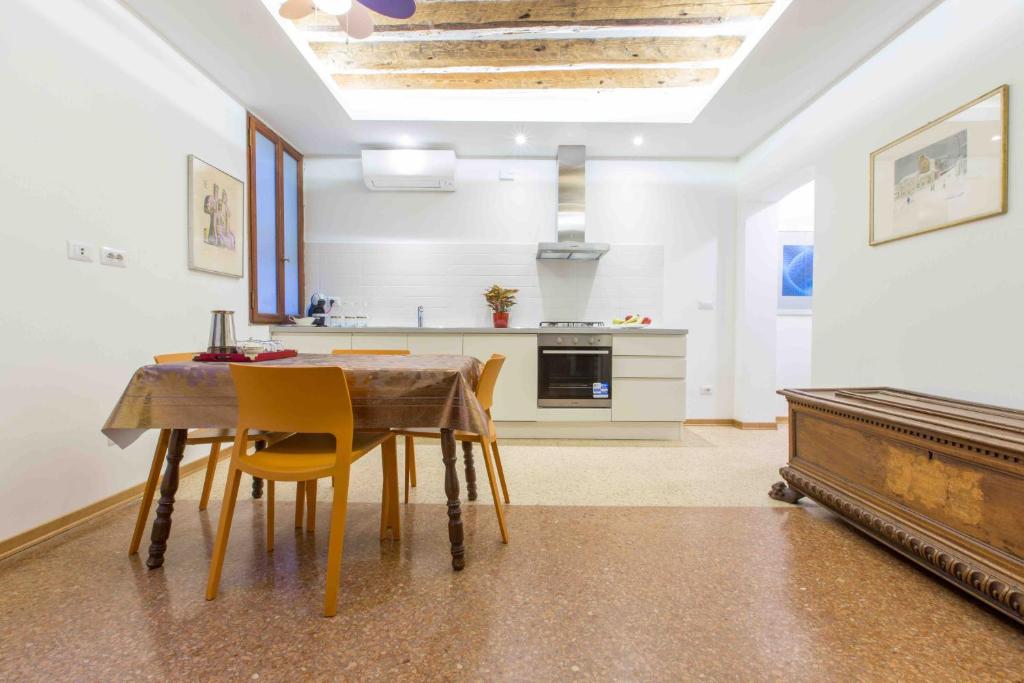 kuchnia i jadalnia ze stołem i krzesłami w obiekcie CA GRIMANI private terrace w Wenecji