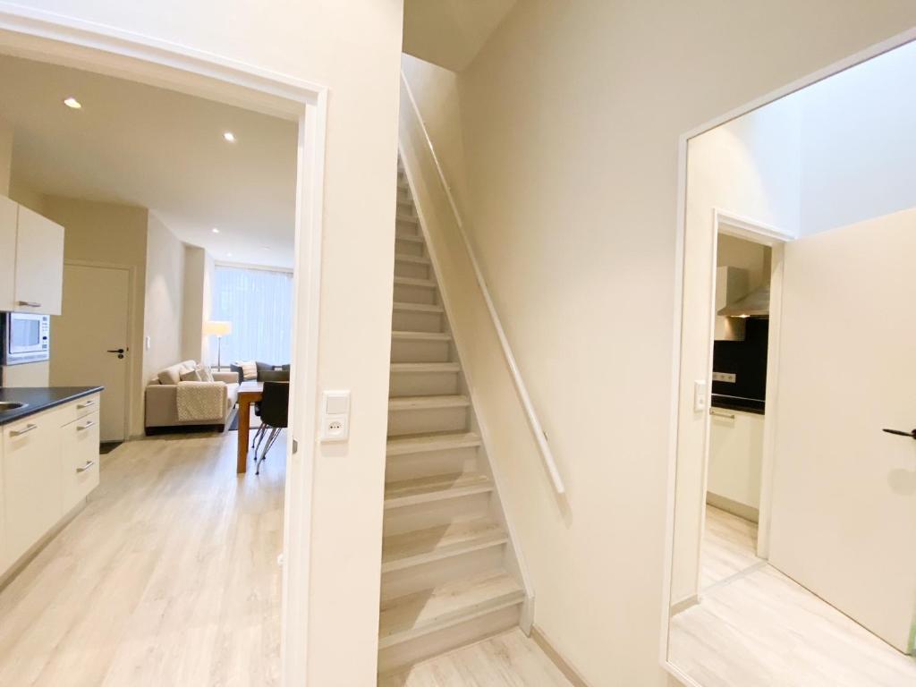 a staircase in a house with a glass door at Vakantiehuis in het Centrum van Domburg DO19 in Domburg