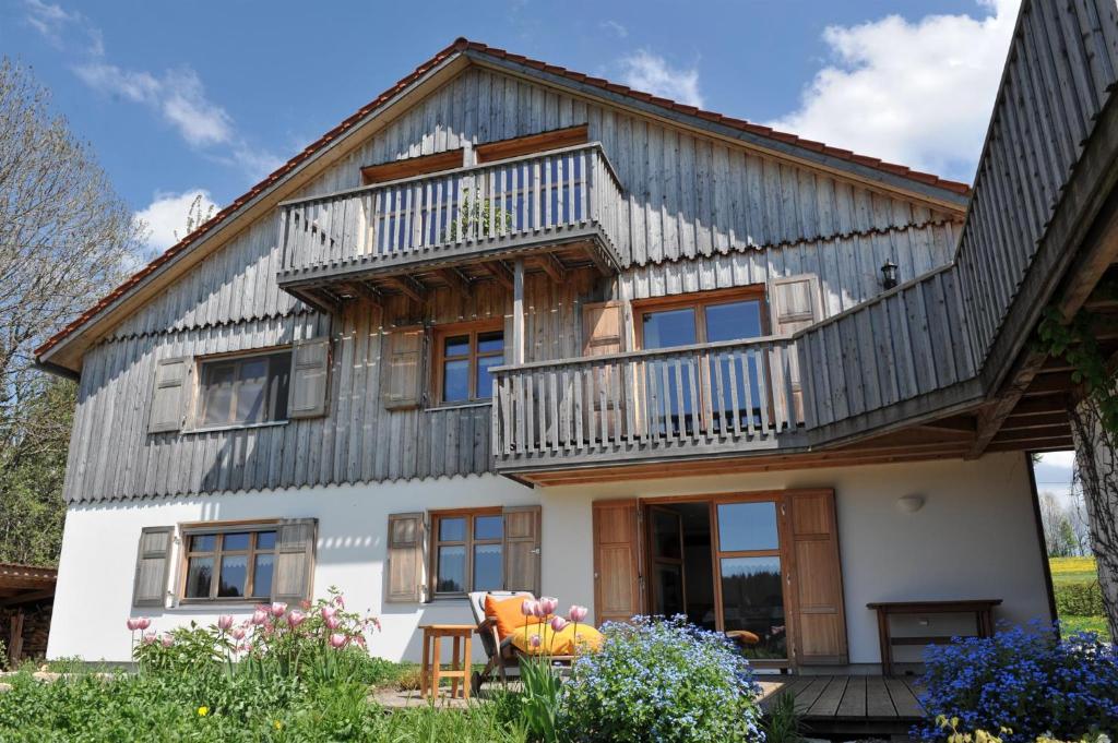 una grande casa con tetto di gambero di Ferienwohnung Wild a Maierhöfen