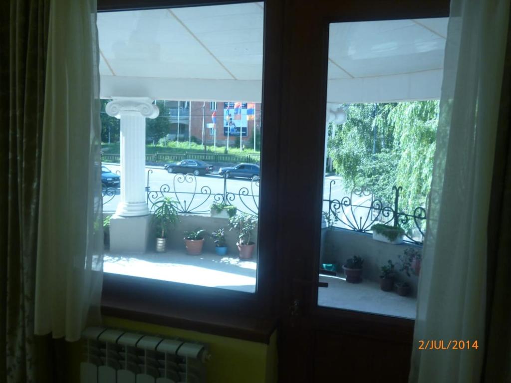 a window view of a courtyard with potted plants at GAH in Tsaghkadzor