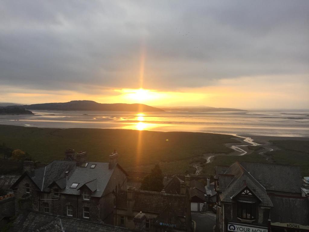 un tramonto su un corpo d'acqua con case di The View a Grange Over Sands