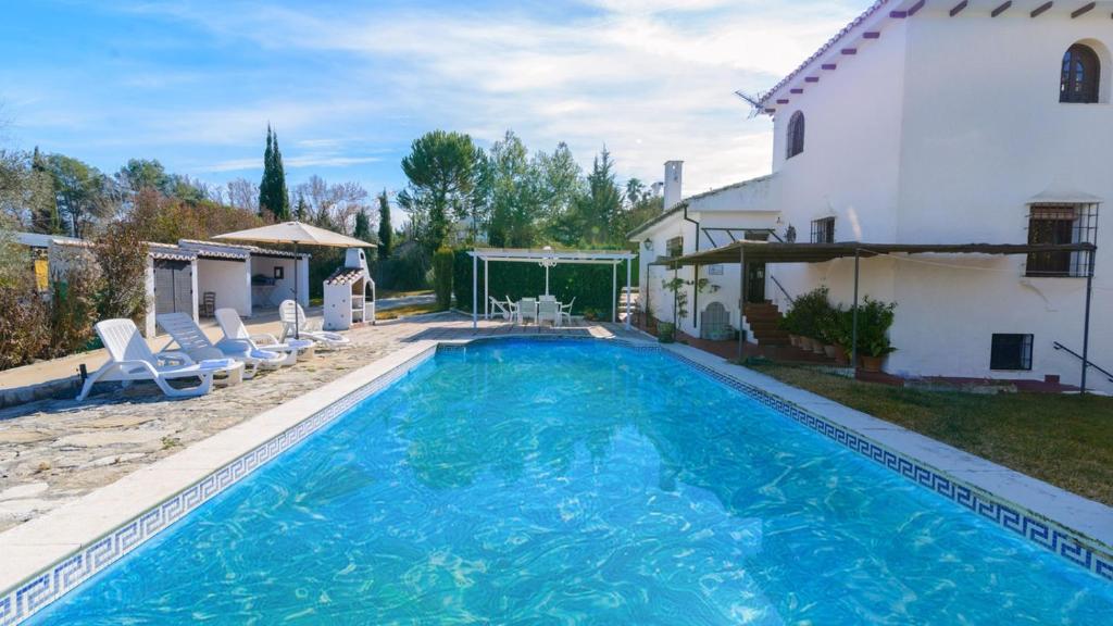 a swimming pool in front of a house at Casa El Rosario Ronda by Ruralidays in Ronda