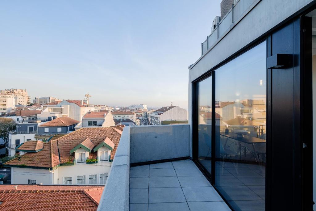 a view of a city from the balcony of a building at BOUTIQUE Rentals- ATTICO Luxury Design-Ocean views in Porto