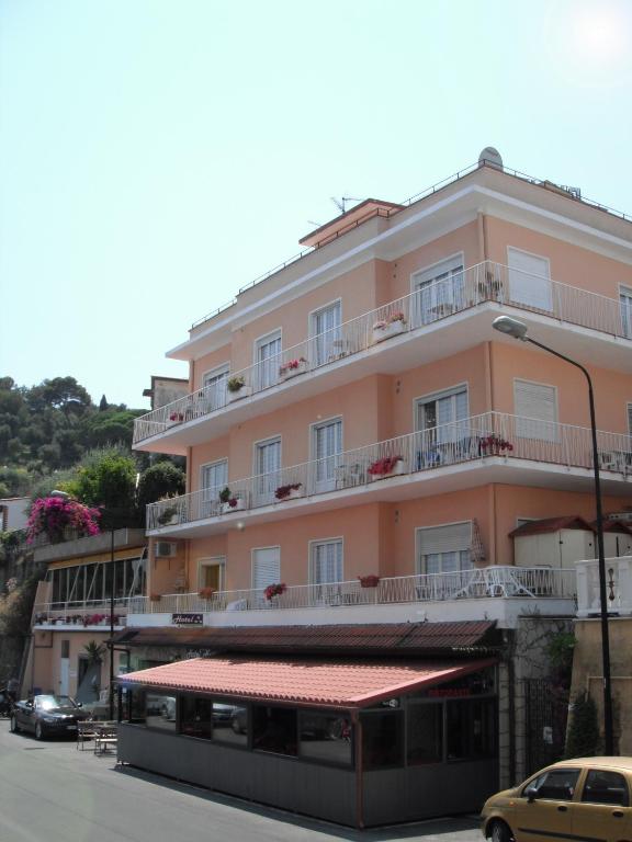 a building with a bus parked in front of it at Hotel Nettuno in Diano Marina